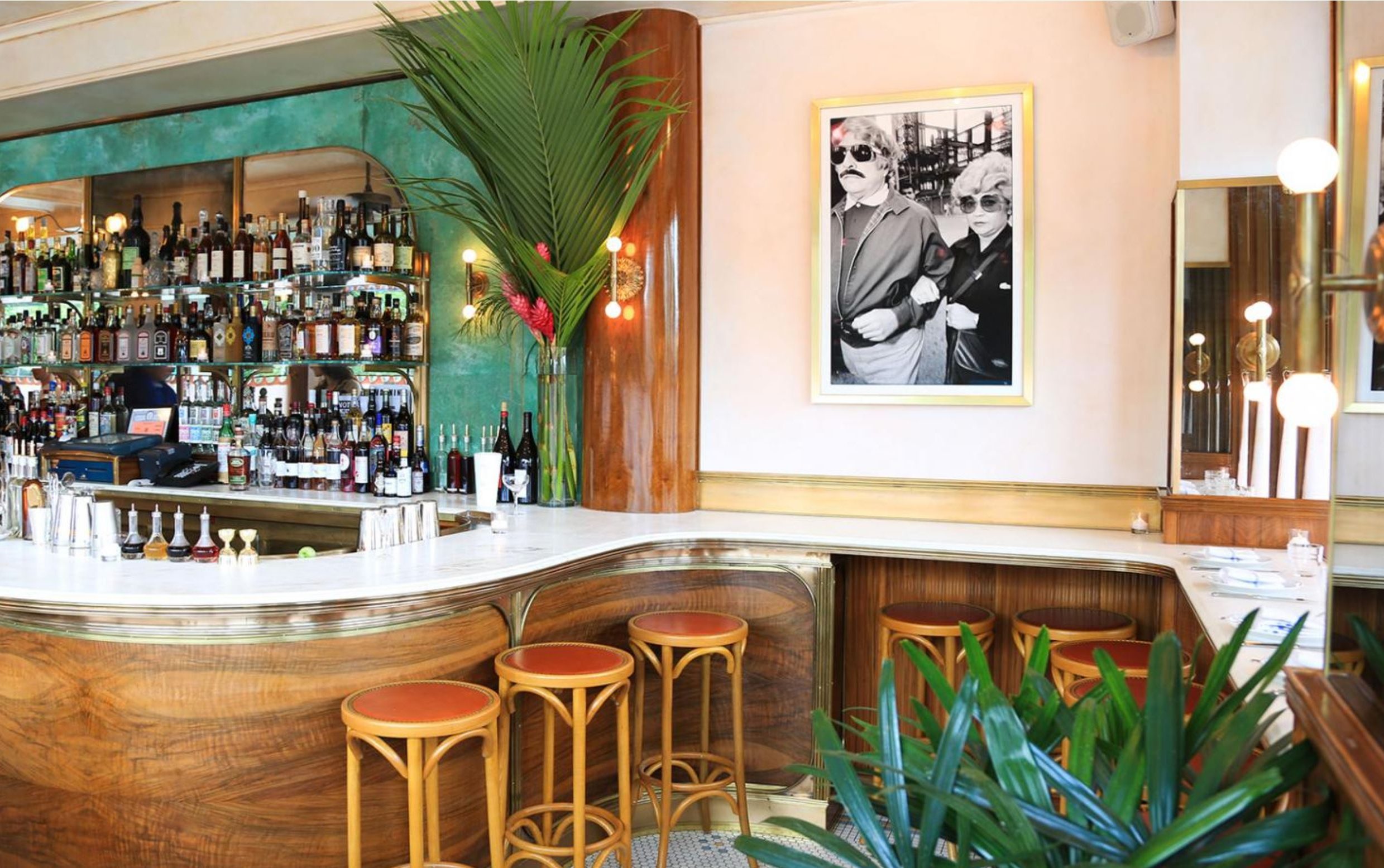 wood bar with stools and palm leaves
